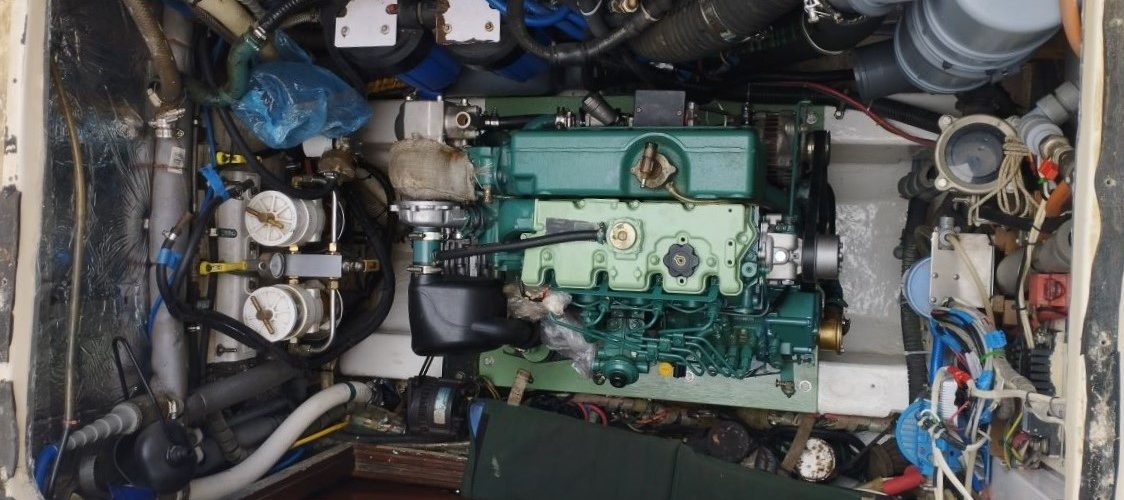 looking down into a boat's engine room onto the engine